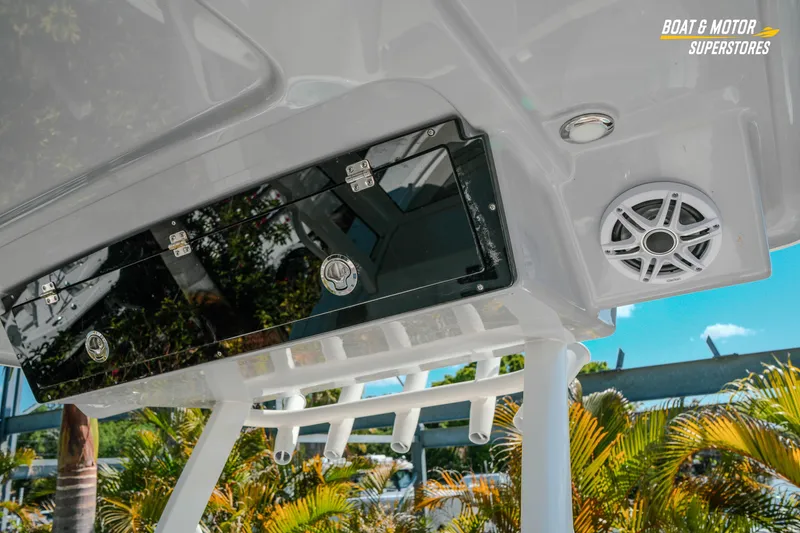 Slide: The Image of 2026 Key West 260 Center Console boat with speaker and storage compartment, tropical background. - 31