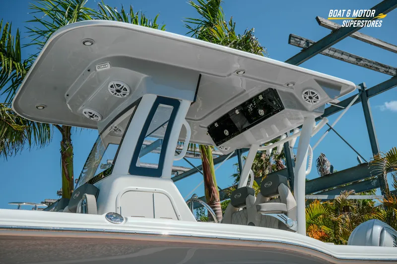 Slide: The Image of 2026 Key West 260 Center Console boat with T-top and seating, under clear blue sky. - 4