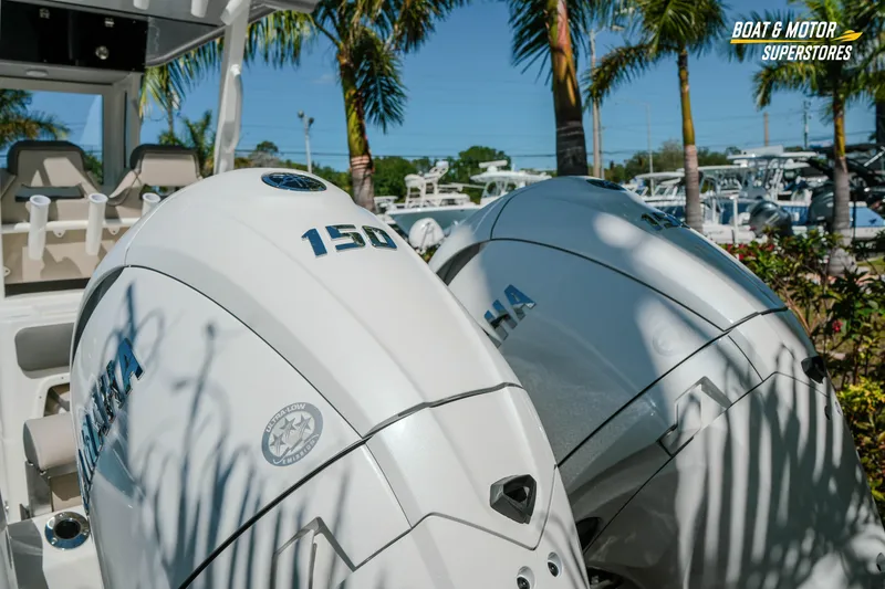Slide: The Image of 2026 Key West 260 Center Console with dual Yamaha 150 engines, displayed outdoors. - 7