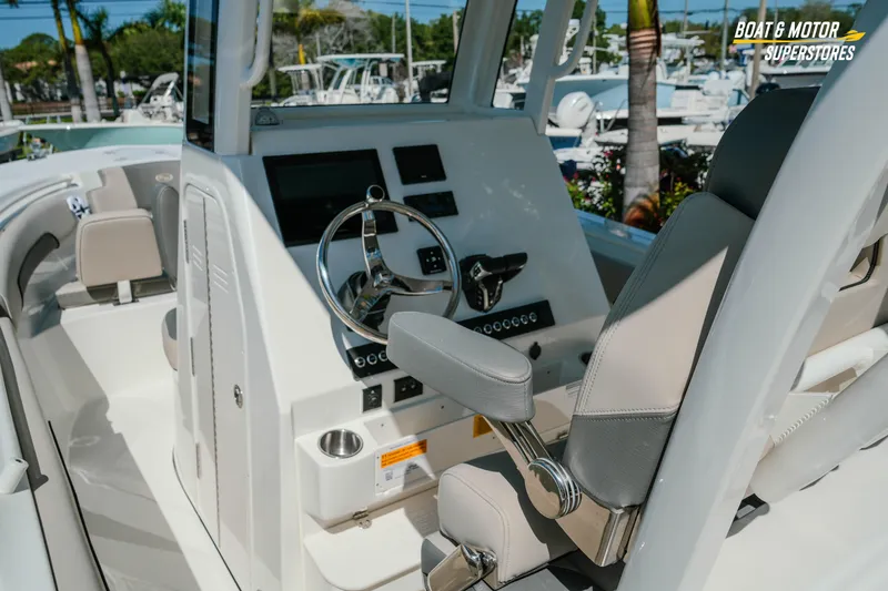 Slide: The Image of 2026 Key West 260 Center Console boat interior with steering wheel and seating. - 8