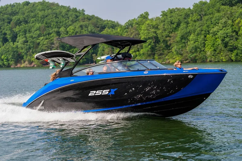 Slide: The Image of Manufacturer Provided Image: 2026 Yamaha Boats 255XD cruising on a lake with lush green forest backdrop. - 1