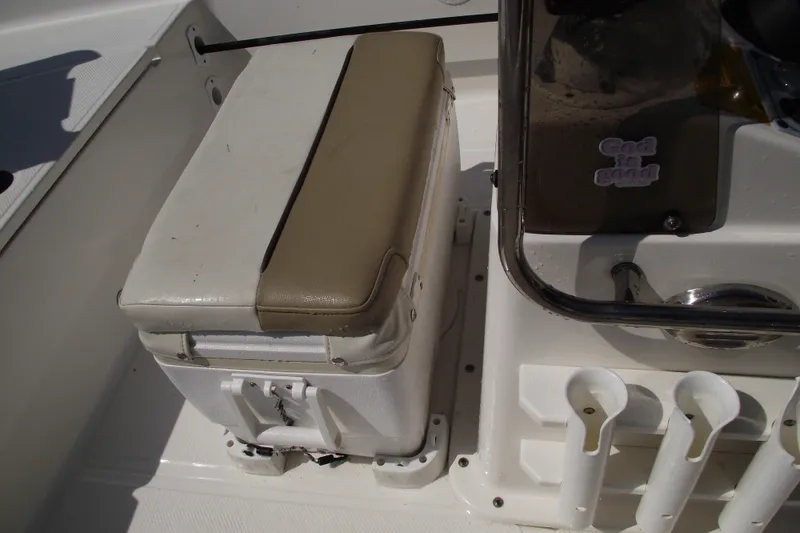 Slide: The Image of 2017 Key West 1520 Center Console boat interior with cushioned seat and rod holders. - 12