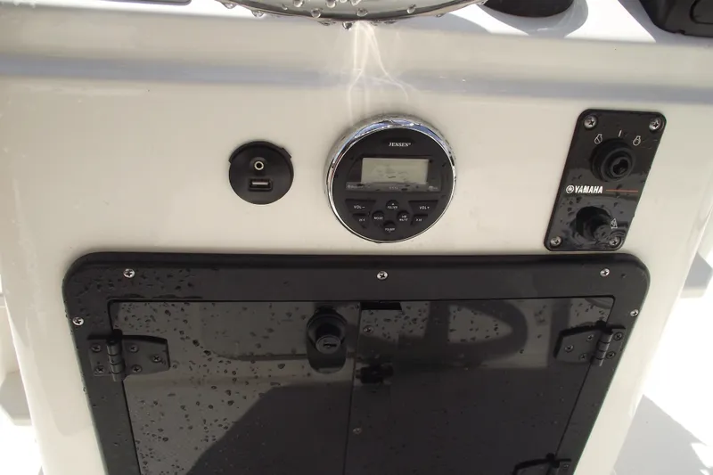 Slide: The Image of 2017 Key West 1520 Center Console dashboard with Jensen stereo and Yamaha controls. - 17