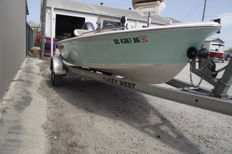 Slide: The Image of 2017 Key West 1520 Center Console boat on trailer, parked outdoors. - 2