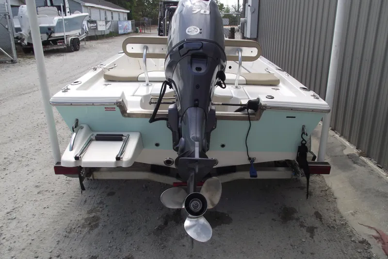 Slide: The Image of 2017 Key West 1520 Center Console boat with outboard motor, parked on a trailer. - 3