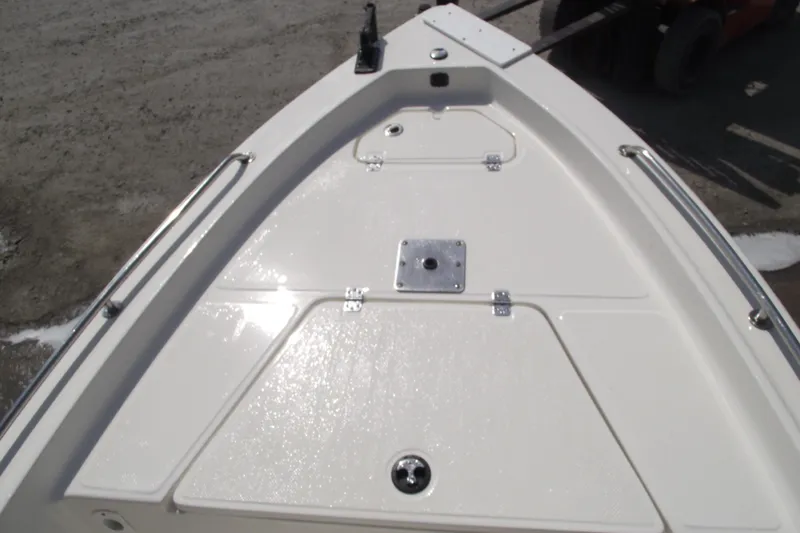 Slide: The Image of 2017 Key West 1520 Center Console boat deck, featuring storage compartments and stainless steel fittings. - 8