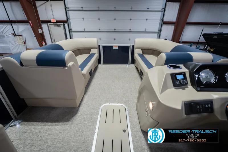 Slide: The Image of 2026 Bennington 21 SLJ pontoon boat interior with beige and blue seating, and control panel. - 16