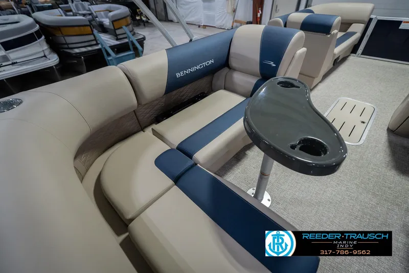 Slide: The Image of 2026 Bennington 21 SLJ pontoon boat interior with beige and blue seating, cupholder table. - 38