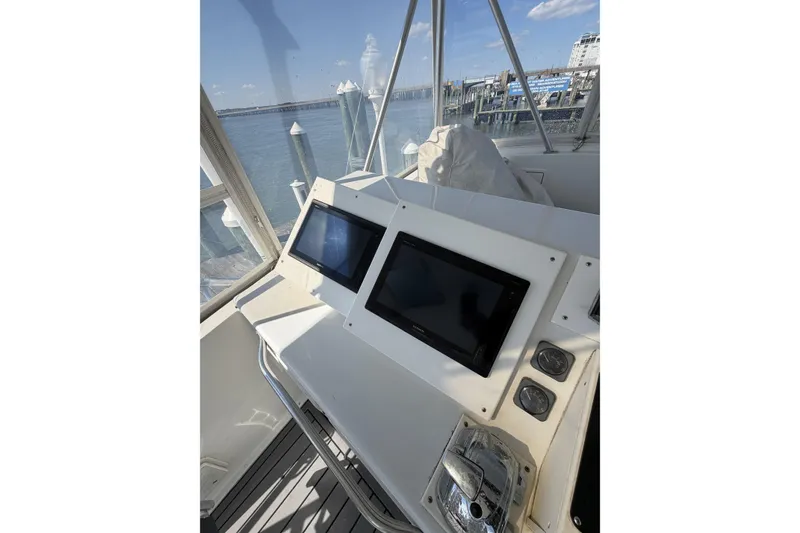 Slide: The Image of Cockpit of 1990 Ocean Yachts 48 Super Sport with navigation screens and controls. - 10