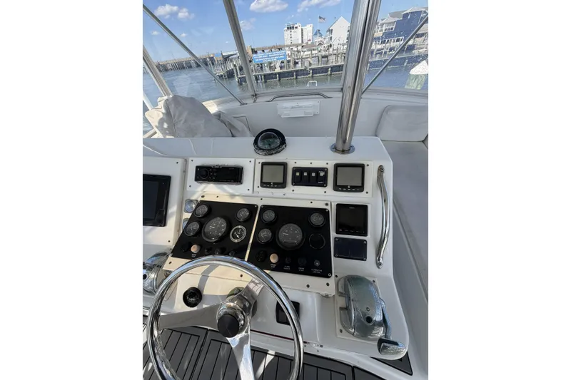 Slide: The Image of 1990 Ocean Yachts 48 Super Sport helm with gauges and controls, dockside view. - 11