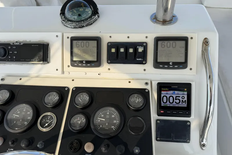 Slide: The Image of Control panel of a 1990 Ocean Yachts 48 Super Sport with gauges and navigation instruments. - 12