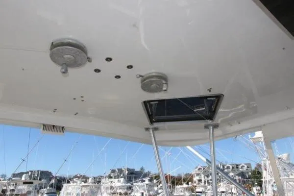 Slide: The Image of Ceiling view of a 2000 Ocean Yacht 48 Super Sport, featuring a hatch and fixtures. - 14