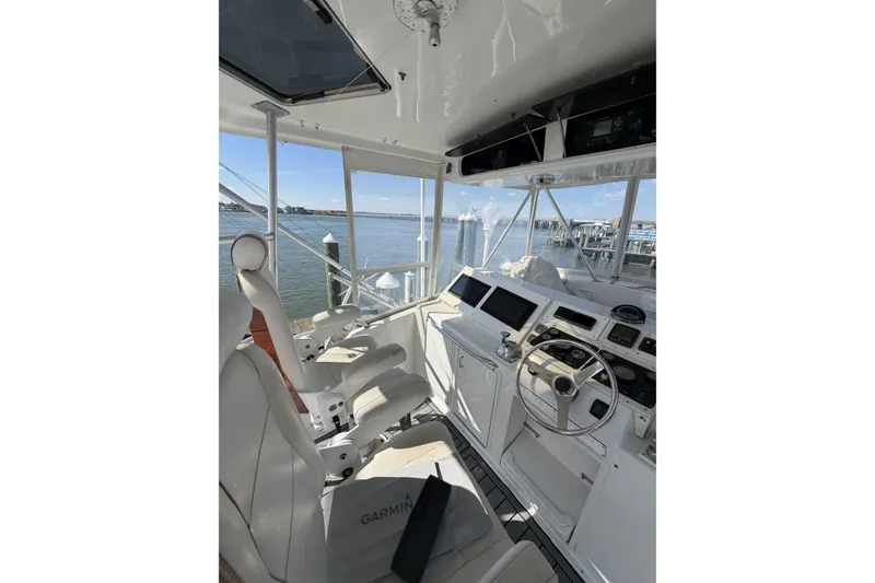 Slide: The Image of Cockpit of 1990 Ocean Yachts 48 Super Sport with modern navigation equipment and waterfront view. - 15