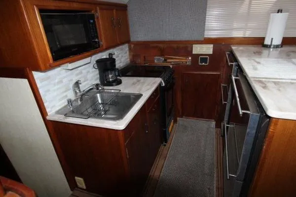 Slide: The Image of Galley kitchen in 2000 Ocean Yacht 48 Super Sport with sink, stove, and microwave. - 17