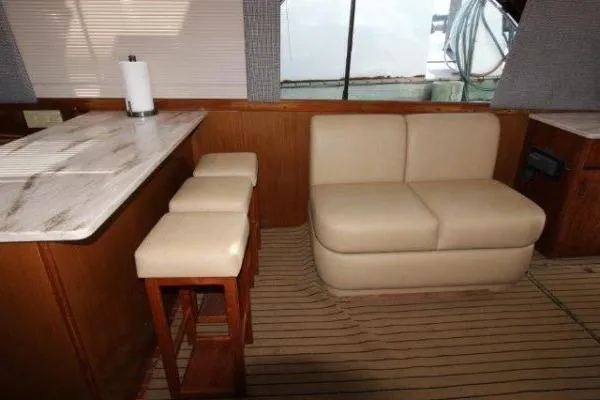 Slide: The Image of Interior of 2000 Ocean Yacht 48 Super Sport with beige seating and bar stools. - 20