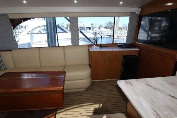 Slide: The Image of Luxurious interior of 2000 Ocean Yacht 48 Super Sport with beige seating and wooden accents. - 23