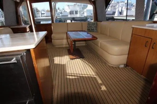 Slide: The Image of Luxurious interior of 2000 Ocean Yacht 48 Super Sport with beige seating and wooden accents. - 25