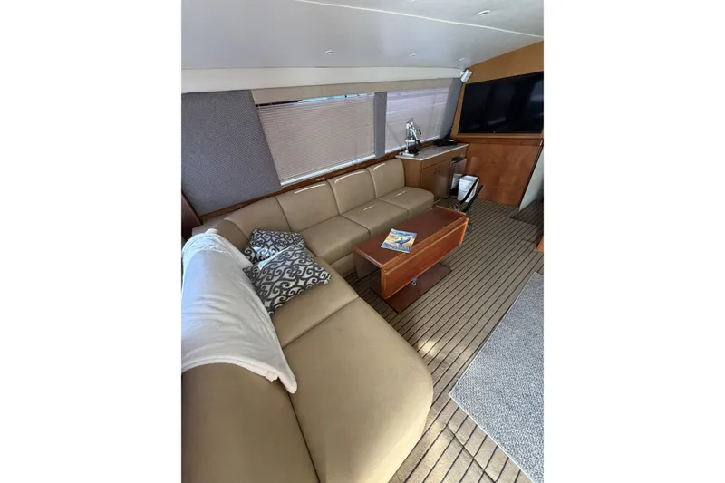 Slide: The Image of Luxurious interior of 1990 Ocean Yachts 48 Super Sport with beige seating and wooden accents. - 26