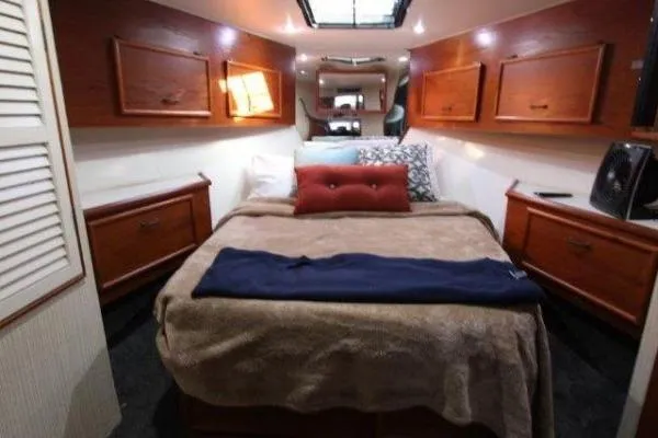 Slide: The Image of Luxurious cabin interior of 2000 Ocean Yacht 48 Super Sport with cozy bed and wooden cabinets. - 29