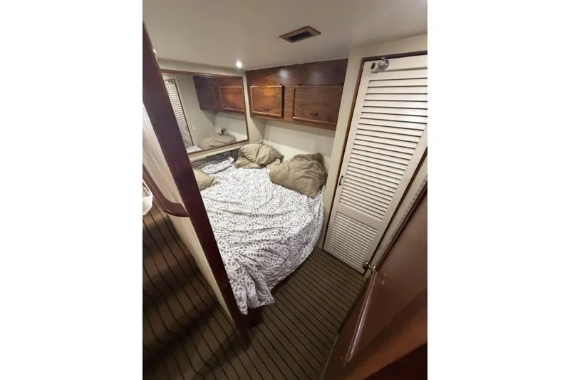 Slide: The Image of Cozy cabin interior of 1990 Ocean Yachts 48 Super Sport with bed and wooden storage. - 32