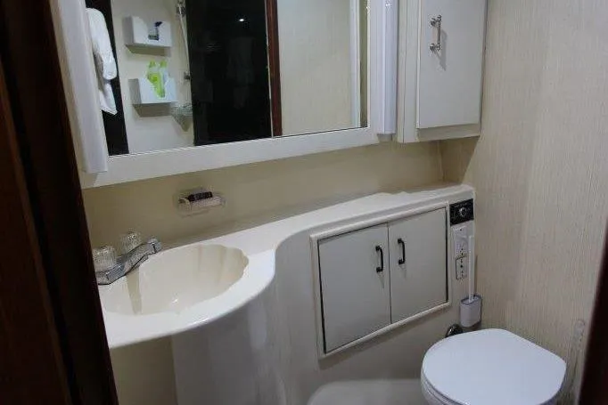 Slide: The Image of Bathroom interior of 2000 Ocean Yacht 48 Super Sport, featuring sink, toilet, and storage cabinets. - 34