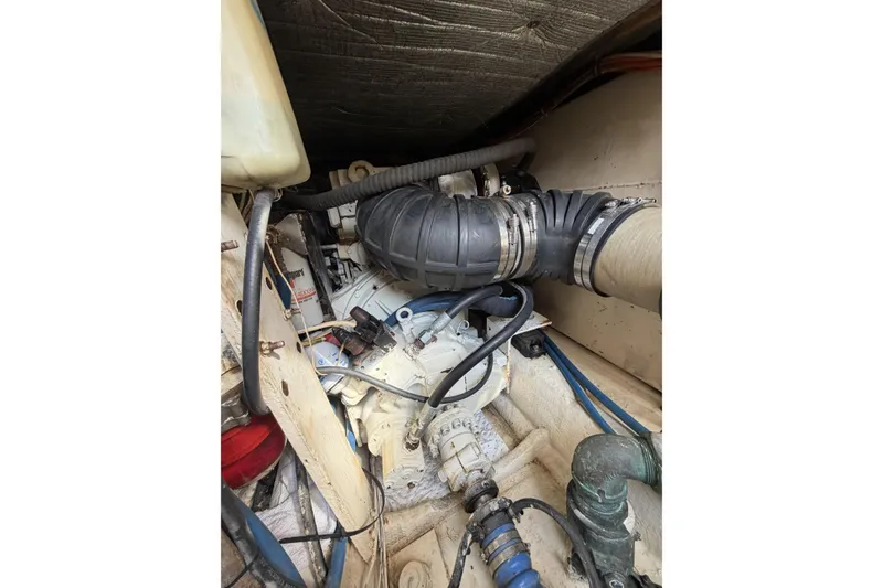 Slide: The Image of Engine compartment of a 1990 Ocean Yachts 48 Super Sport, showcasing hoses and mechanical components. - 39