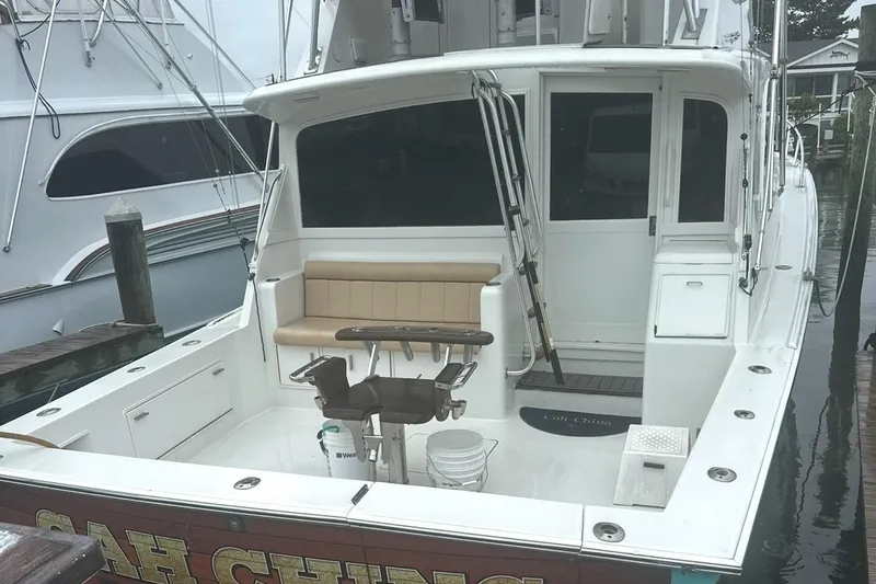 Slide: The Image of 2000 Ocean Yachts 48 Super Sport docked, featuring spacious cockpit and fishing chair. - 5