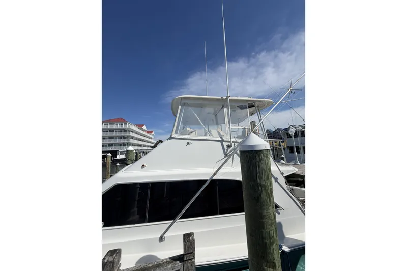 Slide: The Image of 1990 Ocean Yachts 48 Super Sport docked under clear blue sky. - 7