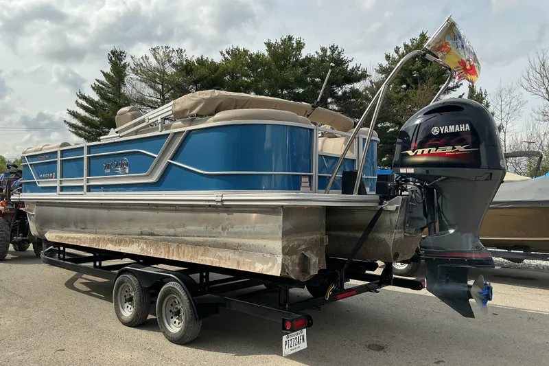 The Image of 2024 SunCatcher Fusion 322RC pontoon boat with Yamaha VMAX engine on trailer. - 1
