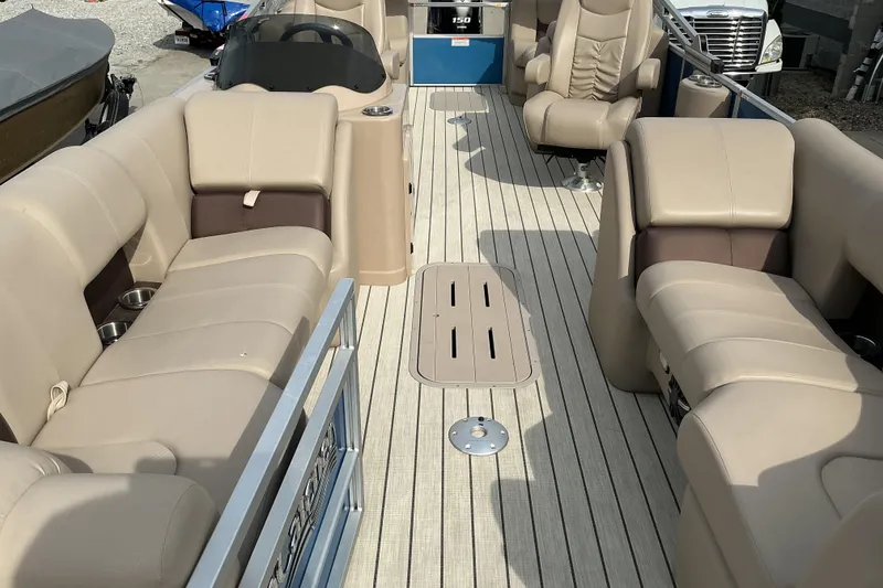Slide: The Image of 2024 SunCatcher Fusion 322RC pontoon boat interior with beige seating and modern design. - 5