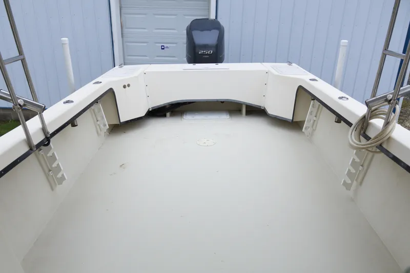 Slide: The Image of 2000 May-Craft 2550 Cabin boat interior with spacious deck and outboard motor. - 18