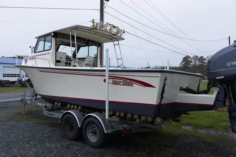 Slide: The Image of 2000 May-Craft 2550 Cabin boat on trailer, side view, outdoors. - 3