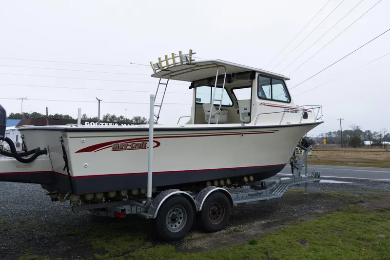 Slide: The Image of 2000 May-Craft 2550 Cabin boat on trailer, side view, parked outdoors. - 6