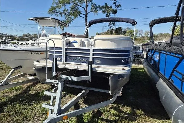 The Image of 2014 SunChaser 8522 C-N-F pontoon boat on trailer, parked outdoors. - 1