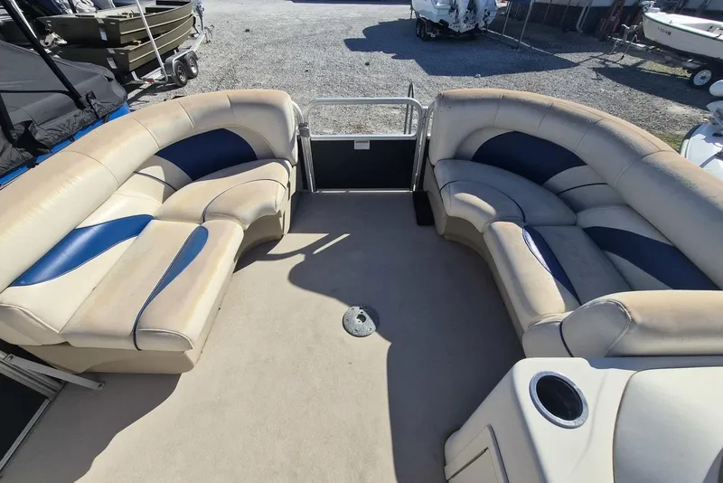 Slide: The Image of 2014 SunChaser 8522 C-N-F pontoon boat interior with beige and blue seating. - 3