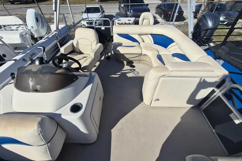 Slide: The Image of 2014 SunChaser 8522 C-N-F pontoon boat interior with beige and blue seating. - 4