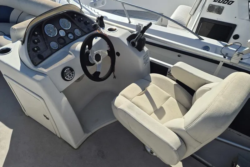 Slide: The Image of 2014 SunChaser 8522 C-N-F boat helm with steering wheel and control panel. - 5