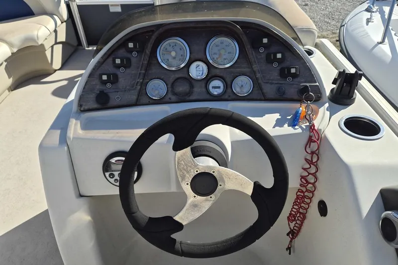 Slide: The Image of Steering console of a 2014 SunChaser 8522 C-N-F pontoon boat with gauges and controls. - 6