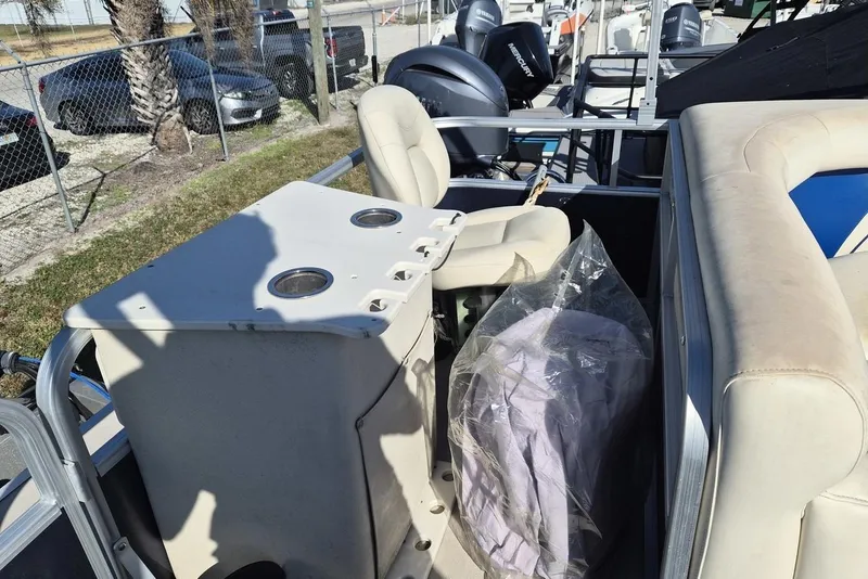 Slide: The Image of 2014 SunChaser 8522 C-N-F pontoon boat interior with seating and console. - 8