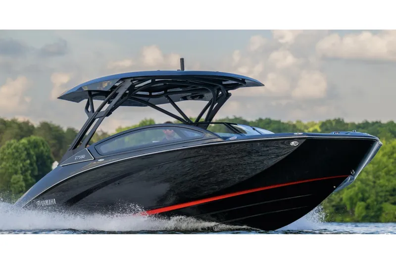 Slide: The Image of Manufacturer Provided Image: 2025 Yamaha Boats 275SD cruising on a lake with lush green trees in the background. - 2