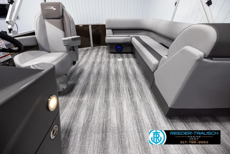 Slide: The Image of Interior of 2025 Bennington 21 SL with gray seating and carpet flooring. - 14