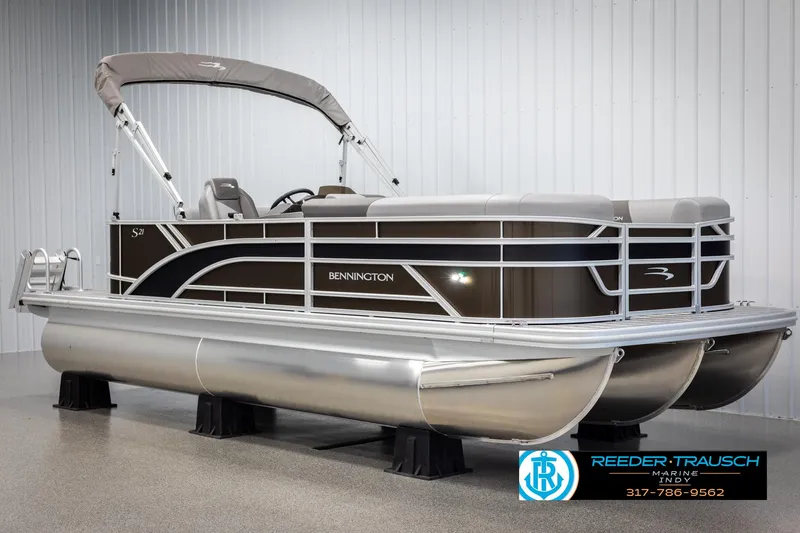 Slide: The Image of 2025 Bennington 21 SL pontoon boat displayed in showroom. - 2