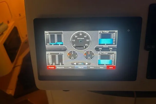 Slide: The Image of Dashboard display of a 2003 Grady-White Express 330 boat, showing engine metrics. - 10