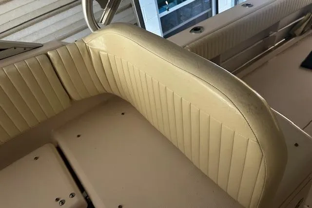 Slide: The Image of 2003 Grady-White Express 330 boat interior with beige cushioned seating. - 16