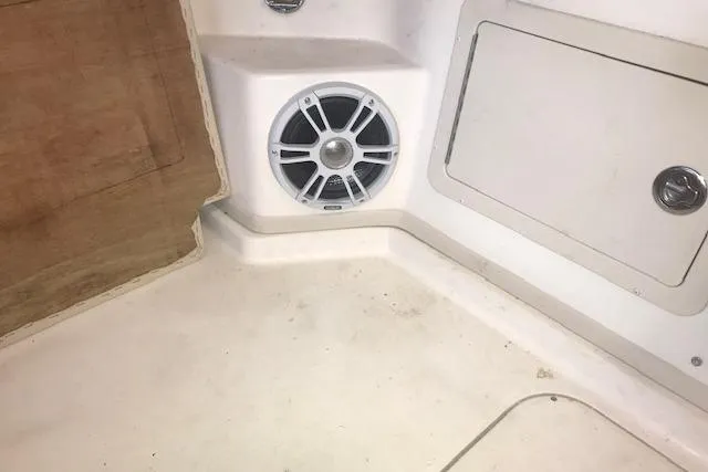 Slide: The Image of 2003 Grady-White Express 330 boat interior with speaker and storage compartment. - 19