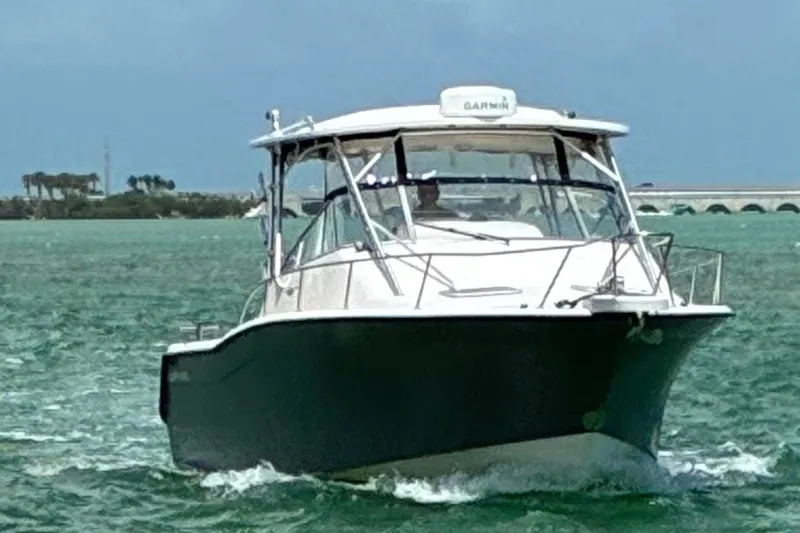 Slide: The Image of 2003 Grady-White Express 330 boat cruising on turquoise waters. - 2