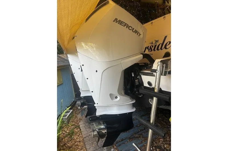Slide: The Image of Twin Mercury outboard engines on a 2003 Grady-White Express 330 boat. - 24