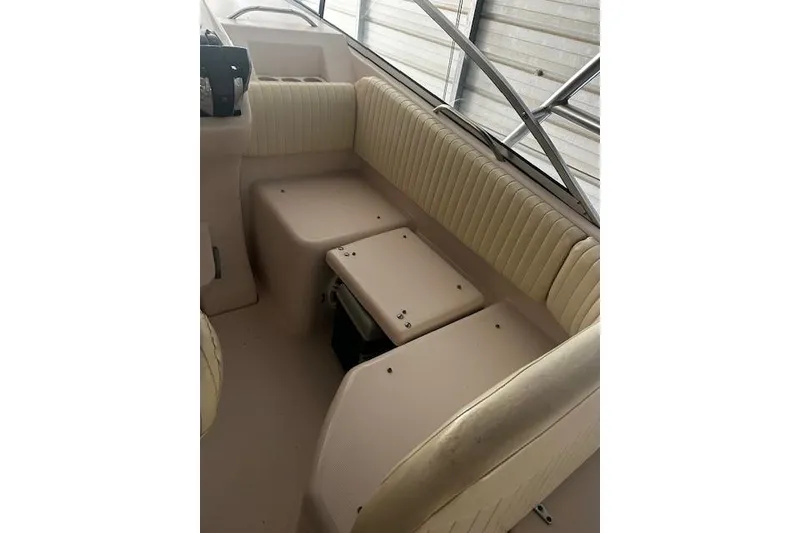 Slide: The Image of Interior seating of 2003 Grady-White Express 330 boat, featuring beige upholstery. - 27