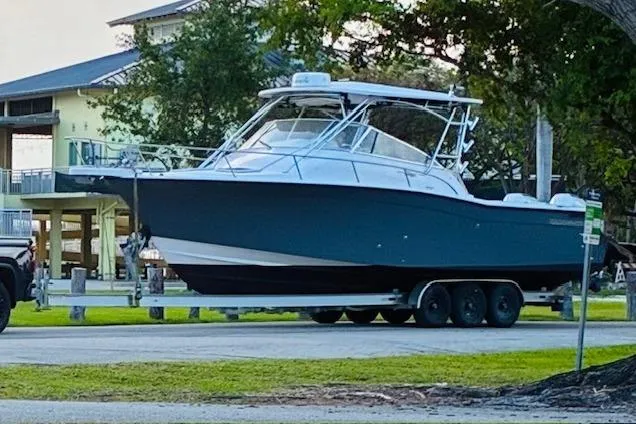 Slide: The Image of 2003 Grady-White Express 330 boat on trailer in a park setting. - 3
