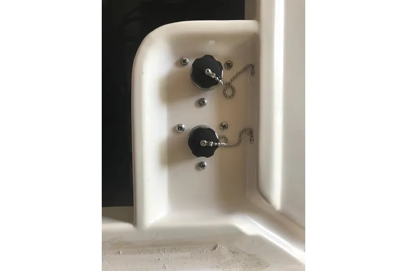 Slide: The Image of 2003 Grady-White Express 330 boat fittings with black caps and chains. - 38